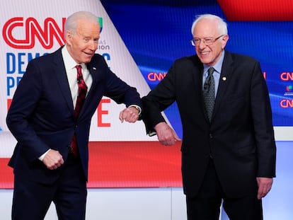 Former Vice President Joe Biden, left, and Sen. Bernie Sanders, I-Vt., right, greet each other before they participate in a Democratic presidential primary debate at CNN Studios in Washington, Sunday, March 15, 2020. (AP Photo/Evan Vucci)