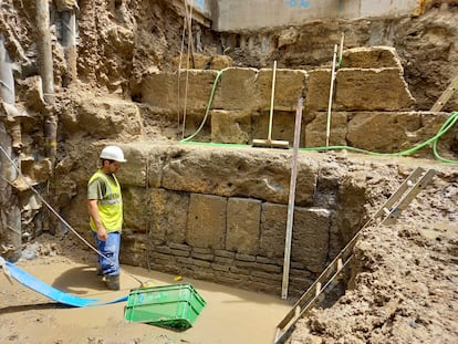 Un obrero, ante la parte exterior de la muralla romana hallada en Sevilla.