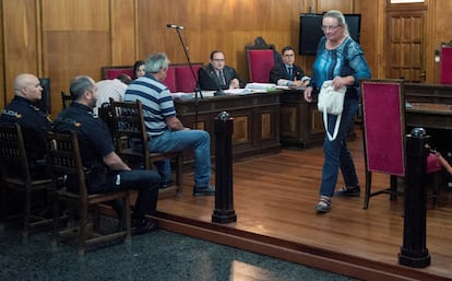 Margo Pool se cruza con los dos hermanos acusados (Juan Carlos y Julio, sentados ante dos policias) en la Audiencia de Ourense, al terminar de declarar durante la segunda sesión del juicio por la muerte de Martin Verfondern, en junio de 2018.