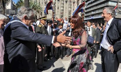 Cristina Fernández de Kirchner, greeting José Mujica in 2010 with her late husband, Néstor Kirchner, standing on the right.