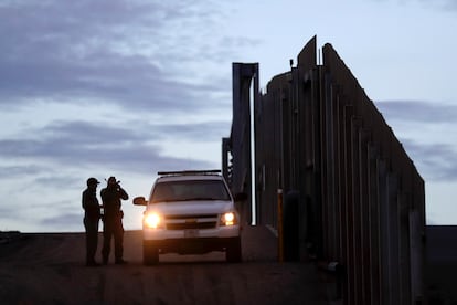 U.S. Border Patrol agents stand guard near one of the border walls separating Tijuana and San Diego, California.