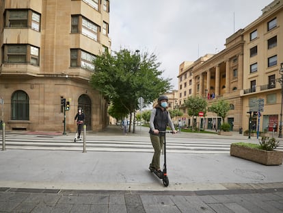 Scooter riders wear face masks in Pamplona, Navarre, where new restrictions have been introduced in one neighborhood.