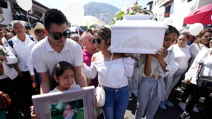 Relatives carry the coffin that contain the remains of a young girl named Camila, in Taxco, Mexico, Friday, March 29, 2024. The 8-year-old girl disappeared Wednesday; her body was found on a road on the outskirts of the city early Thursday. Later that day a mob beat a woman to death because she was suspected of kidnapping and killing the young girl. (AP Photo/Fernando Llano)