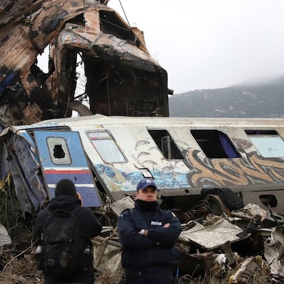 A crane removes debris after trains' collision in Tempe, about 376 kilometres (235 miles) north of Athens, near Larissa city, Greece, Thursday, March 2, 2023. Using cranes and heavy machinery, rescuers Thursday searched the wreckage of trains involved in a deadly collision that sent Greece into national mourning and prompted strikes and protests over rail safety. (AP Photo/Vaggelis Kousioras)