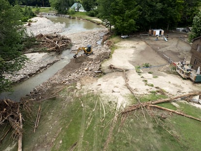 A photo made with a drone of a large backhoe clears debris from the Williams River Middle Branch behind a residential home in Chester, Vermont, USA, 13 July 2023.
