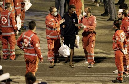 Un migrante recibe asistencia médica por parte de la Cruz Roja tras el desembarco en el puerto de Catania, el 26 de agosto de 2018. 