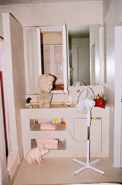 El cerdito y el busto del baño son propiedad de Diana, la pareja del diseñador. El baño, en gresite gris, es del mismo tono que su espacio contiguo, el dormitorio.