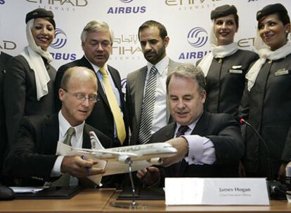 Tom Enders, sentado a la izqda. de Airbus, firma el acuerdo de venta de 55 aviones con James Hogan, de la aerolínea de Abu Dabi.
