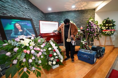 A friend pays his final respects to murdered journalist Lourdes Maldonado who was shot dead in her car when arriving home, in Tijuana, Mexico, Jan. 27, 2022.