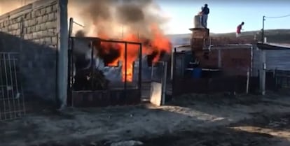 La casa en llamas del padre del hombre acusado falsamente de violador, en un barrio de la periferia de Comodoro Rivadavia, Chubut, Argentina.