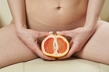 a beautiful slender female body and a cut half of a grapefruit between the legs. the concept of women's health, feminine hygiene, hair removal in the bikini area. High quality photo