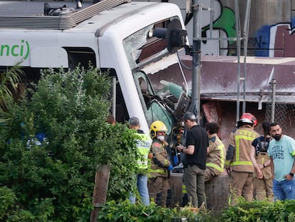 Miembros de los servicios de emergencia y agentes de los Mossos d'Esquadra inspeccionan el lugar en el que se produjo un choque entre un tren de mercancías y uno de pasajeros entre las estaciones de Sant Boi de Llobregat y Molí Nou de la línea Llobregat-Anoia de Ferrocarrils de la Generalitat de Catalunya (FGC).