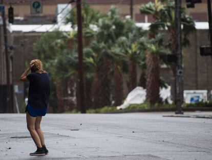 Una mujer se cubre de los vientos y la fuerte lluvia del huracán Florence en Wilmington, Carolina del Norte.
