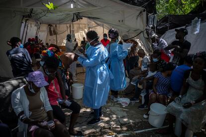 Medical workers tend to patients with cholera symptoms in Port-au-Prince, Haiti.