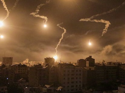 Israeli army flares illuminate the sky over west Gaza in the northern Gaza Strip, on November 6, 2023.