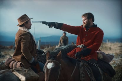 Alexander MacLennan points a gun at Colonel Martin, in a still from the film. 