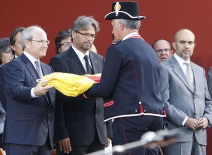 Montilla entrega la bandera catalana al inspector de los <i>mossos</i> en el acto central de la Diada.