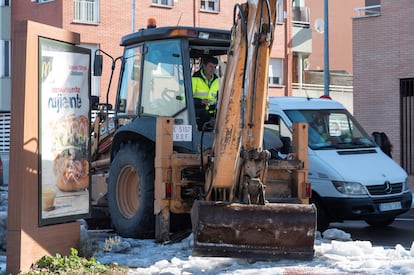 A Madrid city worker clearing a street of snow and debris to prevent flooding ahead of rains expected later this week.