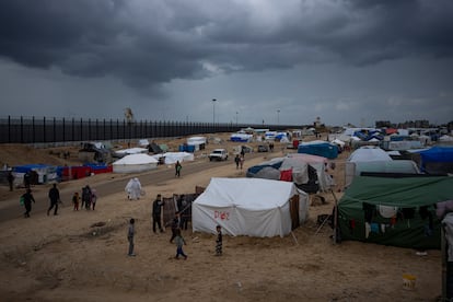 Palestinians displaced by the Israeli air and ground offensive on the Gaza Strip walk through a makeshift tent camp in Rafah on Saturday, Jan. 27, 2024.