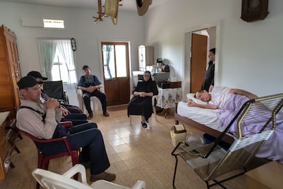 In his final days, Isaac Peter lies in bed, surrounded by the relatives who take care of him, in Riva Palacios. He has a melanoma in his mouth.