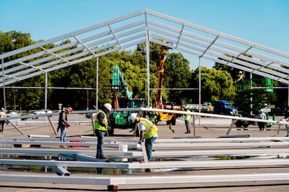 Workers build a huge tent to house migrants, in the Bronx, in September 2022.