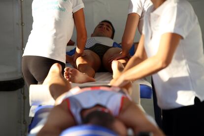 Varios deportistas reciben masajes tras dar por terminada la dura prueba.