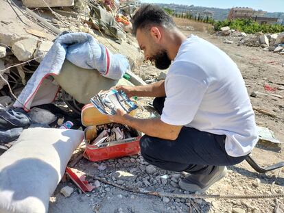 Ashraf Ramadan, with pillow photos of his mother and his brother in Ain el Delb last Thursday. 