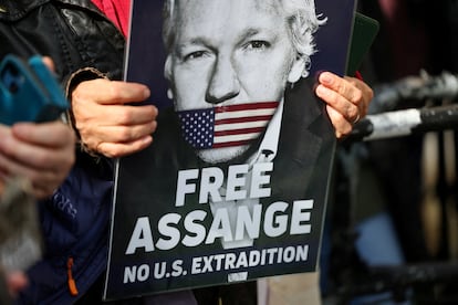 A protester with Julian Assange outside the High Court of England, on March 26 in London.