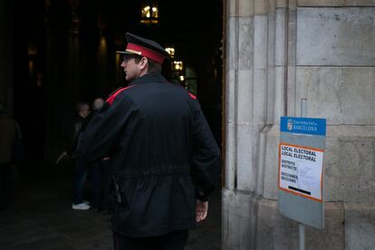 A police officer from the Catalan regional police force, the Mossos D'Esquadra, patrols the entrance of the polling station at the University of Barcelona.