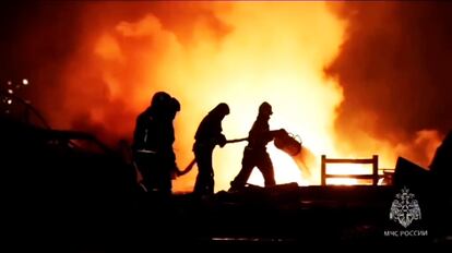 Firefighters work to extinguish a fire at a petrol station on a road near Makhachkala, the capital of Dagestan, Russia, late Monday, Aug. 14, 2023