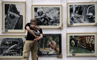 Un asistente a Mulafest observa una exposici&oacute;n fotogr&aacute;fica.