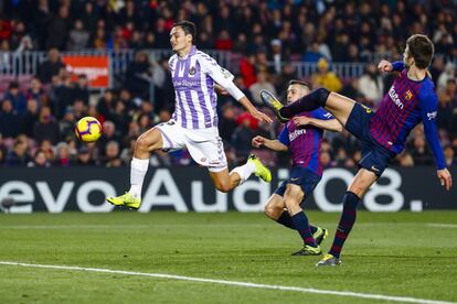 Unal del Valladolid CF y Gerard Pique del FC Barcelona disputan una pelota durante el partido.
