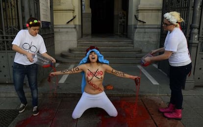 Three members of the protest group Femen protest in front of San Manuel y San Benito church in Madrid to decry Spain's plan to ban women from freely opting for abortion.