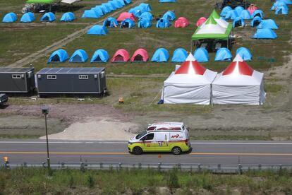 An ambulance passes a scout camping site during the World Scout Jamboree in Buan, South Korea