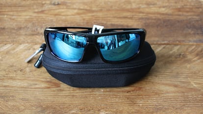 Sports sunglasses on a wooden table.