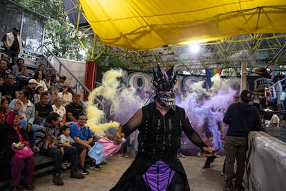 El luchador Nival Banks entra a la arena del Coliseo Morelos portando la bandera de la comunidad trans.