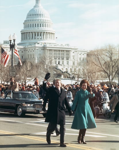 Jimmy Carter, acompañado de su esposa, Rosalynn Carter, recorre las calles cercanas al Capitolio el día de la toma de posesión como presidente de los Estados Unidos, el 20 de enero de 1977. 