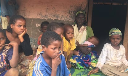 Ousman Kaltoumi, with one of her sons in her arms, at the Timangolo refugee camp.