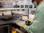 A laboratory technicians handles vials as part of filling and packaging tests for the large-scale production and supply of the University of Oxford�s COVID-19 vaccine candidate, AZD1222, conducted on a high-performance aseptic vial filling line on September 11, 2020 at the Italian biologics� manufacturing facility of multinational corporation Catalent in Anagni, southeast of Rome, during the COVID-19 infection, caused by the novel coronavirus. - Catalent Biologics� manufacturing facility in Anagni, Italy will serve as the launch facility for the large-scale production and supply of the University of Oxford�s Covid-19 vaccine candidate, AZD1222, providing large-scale vial filling and packaging to British-Swedish multinational pharmaceutical and biopharmaceutical company AstraZeneca. (Photo by Vincenzo PINTO / AFP)