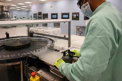 A laboratory technician handles vials as part of filling and packaging tests for the large-scale production and supply of the University of Oxford’s Covid-19 vaccine candidate.