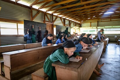 Mennonite children at the San Miguel Gruenwald school. They learn to read and write from the Bible in their language, Plautdietsch. During recess, they play only on the grass; the boys are on one side and the girls on the other.
