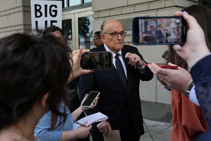 Rudy Giuliani answers questions from the press outside a New York courtroom in May.