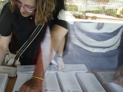 Una mujer consulta las papeletas antes de votar en un colegio electoral instalado en el instituto Rascanya de Valencia, en los comicios europeos de 2009. 