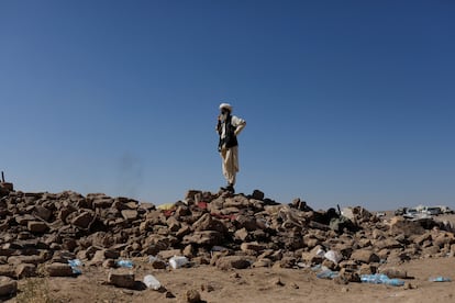 An Afghan man stands on the debris of damaged houses after the recent earthquake, in the district of Zinda Jan, in Herat, Afghanistan October 9, 2023.
