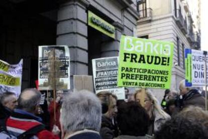 Afectados por las preferentes se manifiestan ante la sede de Bankia situada en el número 1 de la calle Alcalá, en Madrid.