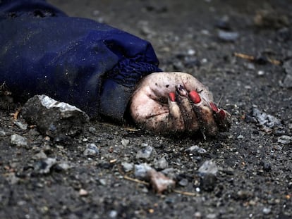 A body of a woman, who according to residents was killed by Russian army soldiers, lies on the street, amid Russia's invasion of Ukraine, in Bucha.