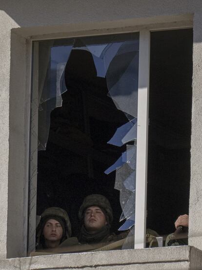 Soldados ucranios miran por la ventana dentro de una instalación militar en Kiev, este sábado. Ucrania cifró hoy en al menos 198 los muertos ucranios por la guerra que lanzó Rusia el pasado jueves contra el país, según el ministro de Sanidad de Ucrania, Víktor Liashkó.