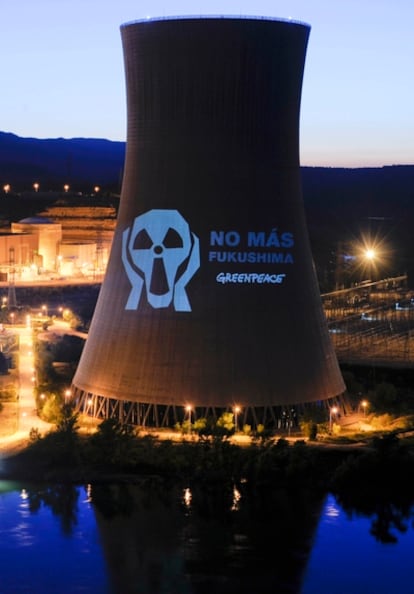 Greenpeace activists project an anti-atomic message on the side of the Ascó nuclear power station in Tarragona.