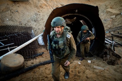 Israeli soldiers exit a tunnel near the border with Israel on December 15, 2023 in northern Gaza.