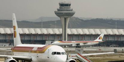 Vista de un avión de Iberia y la torre de control del aeropuerto Madrid-Barajas Adolfo Suárez.